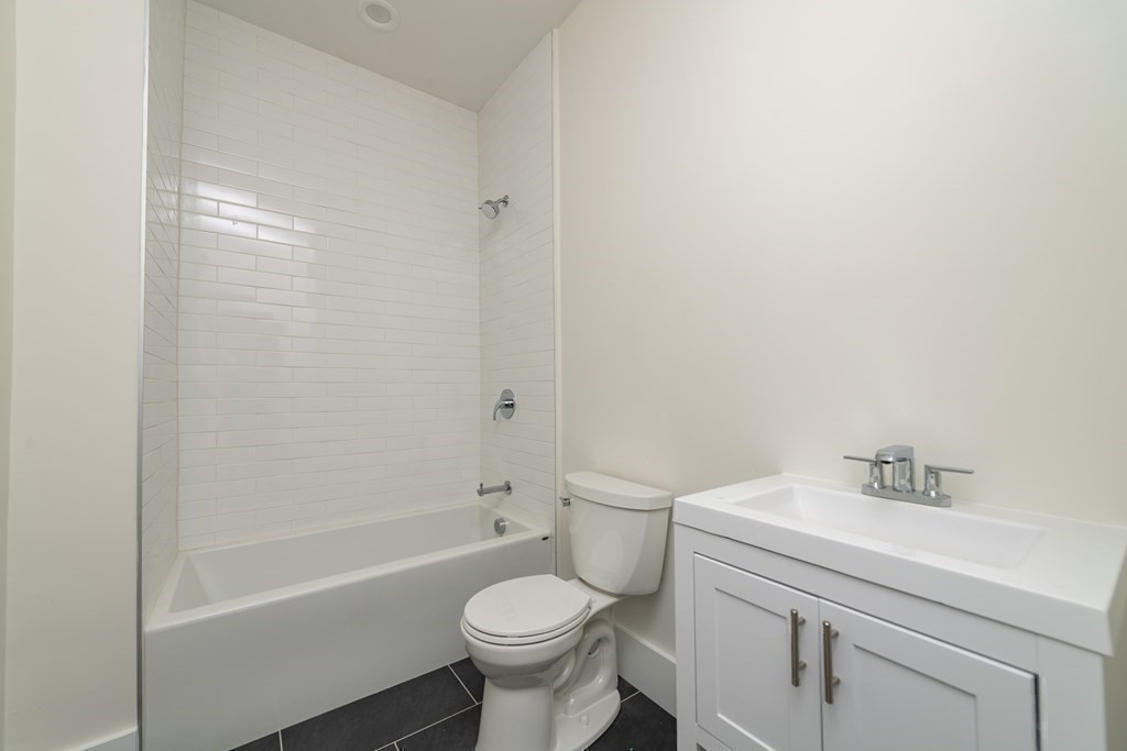 116 School Street, Unit 2 Boston, MA 02119 - Photo 20 of 24 a bathroom with a sink toilet and bathtub