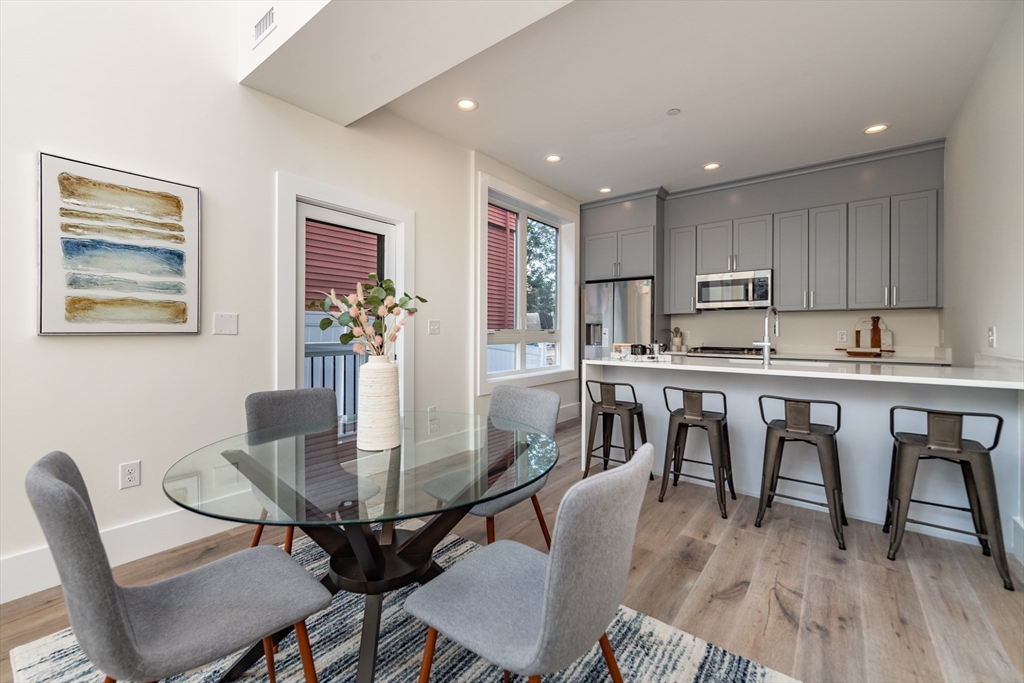 116 School Street, Unit 2 Boston, MA 02119 - Photo 3 of 24 a view of a dining room with furniture and wooden floor