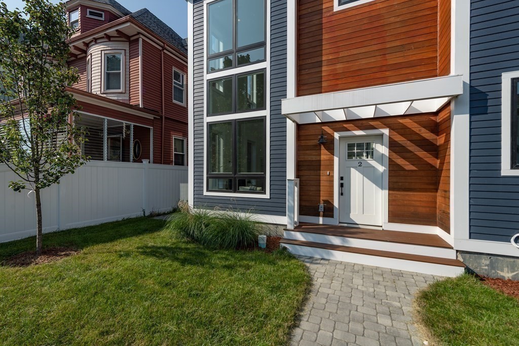 116 School Street, Unit 2 Boston, MA 02119 - Photo 4 of 24 a view of a brick house with a large windows and plants