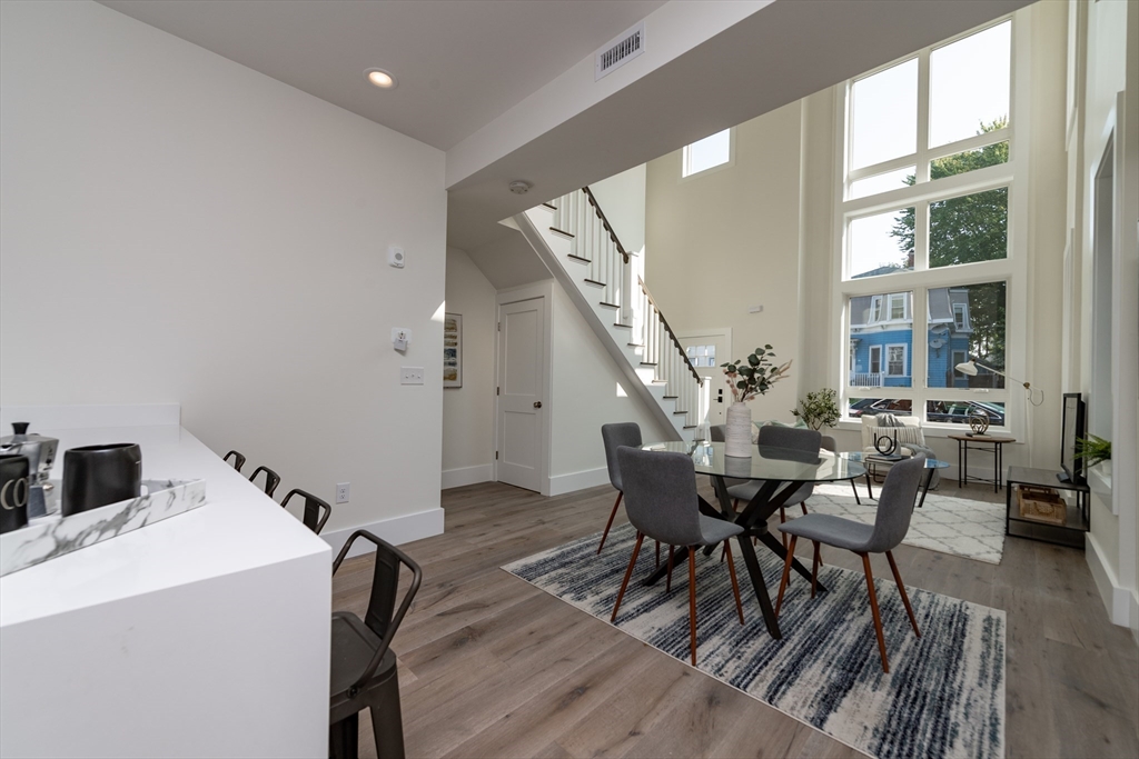 116 School Street, Unit 2 Boston, MA 02119 - Photo 6 of 24 a dining room with furniture and wooden floor