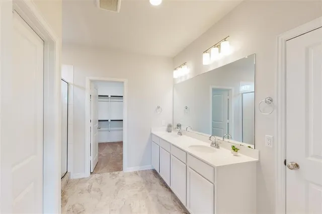 a bathroom with a sink and mirror