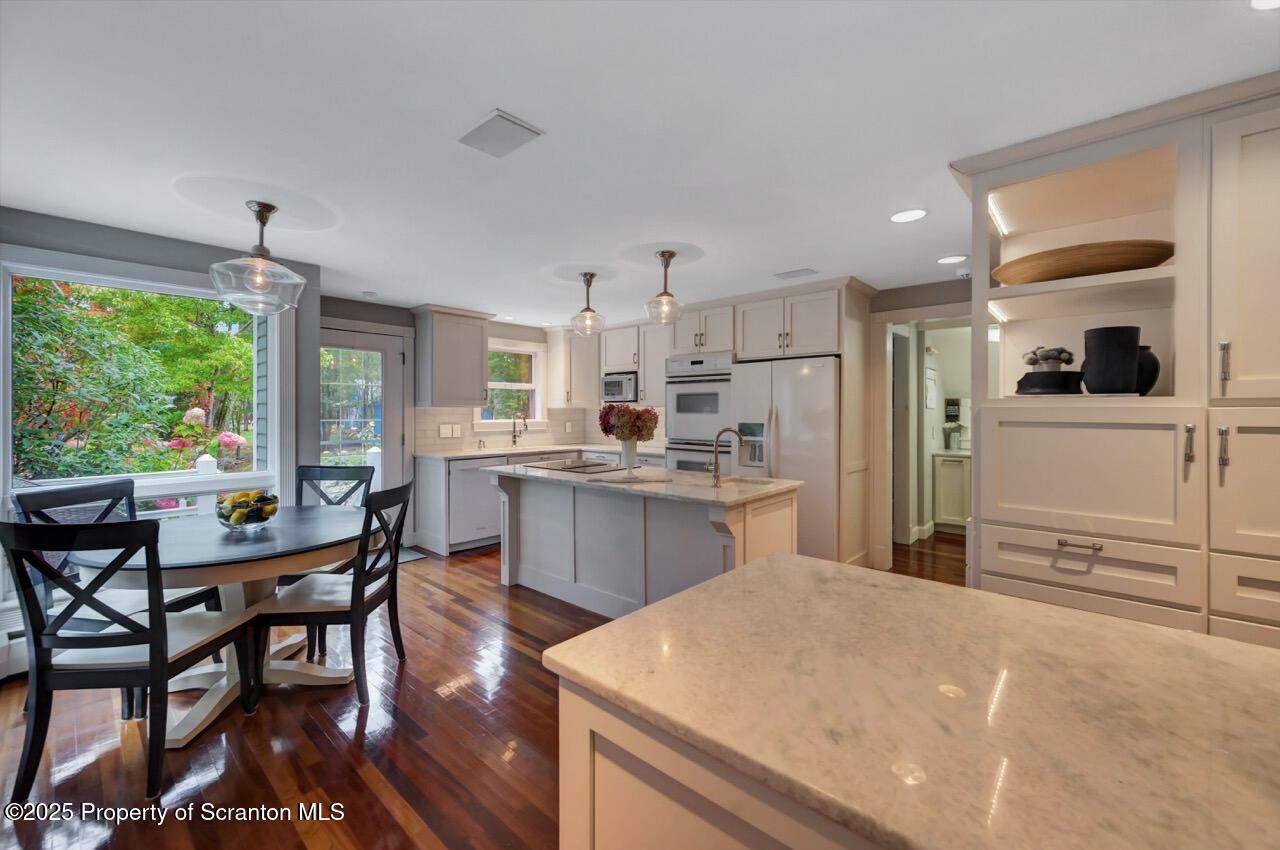 3360 Forest Road Wilkes Barre, PA 18706 - Photo 12 of 88 a kitchen with a table chairs refrigerator and cabinets