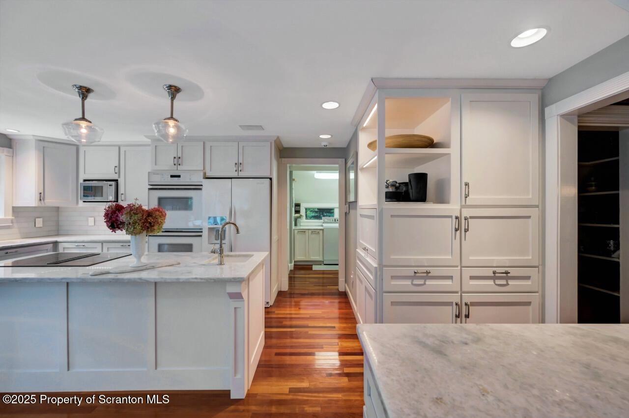 3360 Forest Road Wilkes Barre, PA 18706 - Photo 22 of 88 a kitchen with kitchen island white cabinets and refrigerator