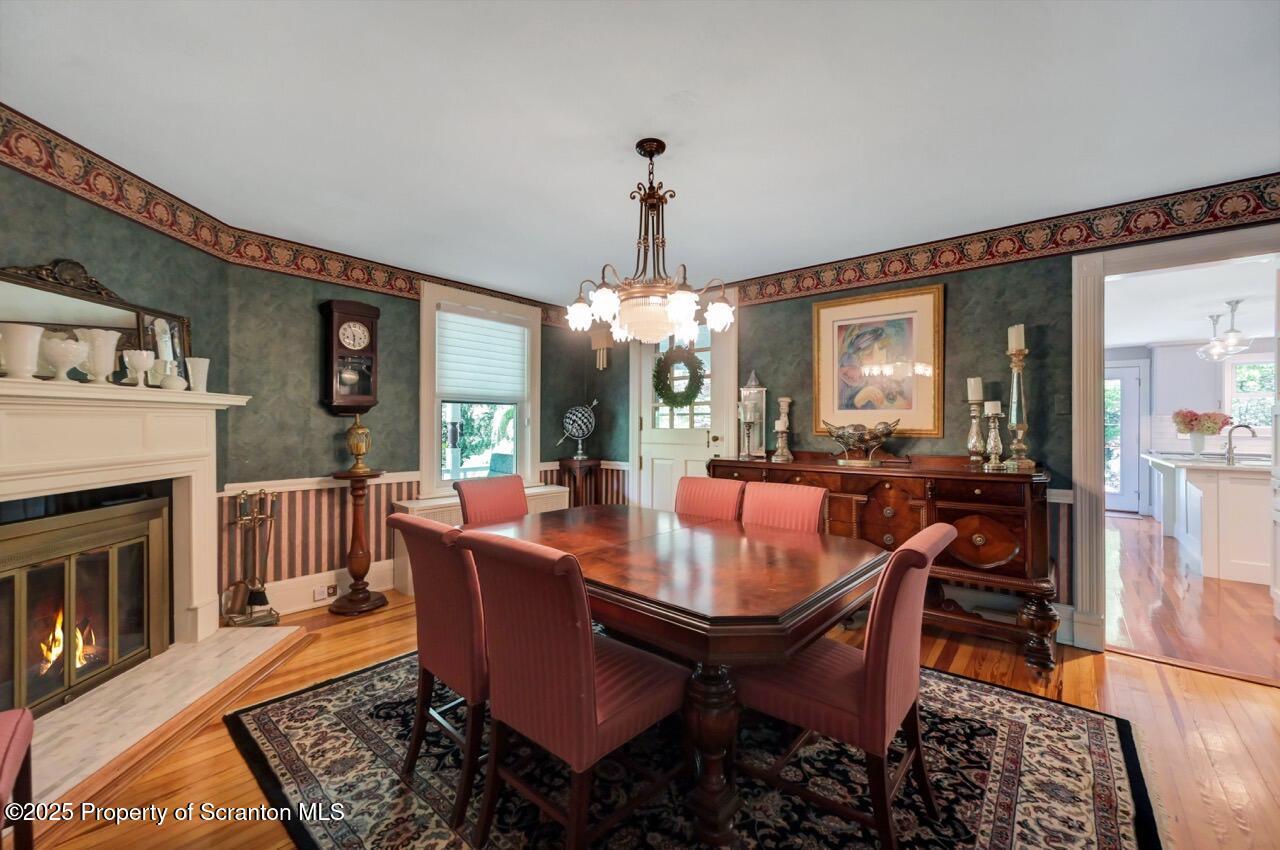 3360 Forest Road Wilkes Barre, PA 18706 - Photo 25 of 88 a dining room with furniture a chandelier and wooden floor