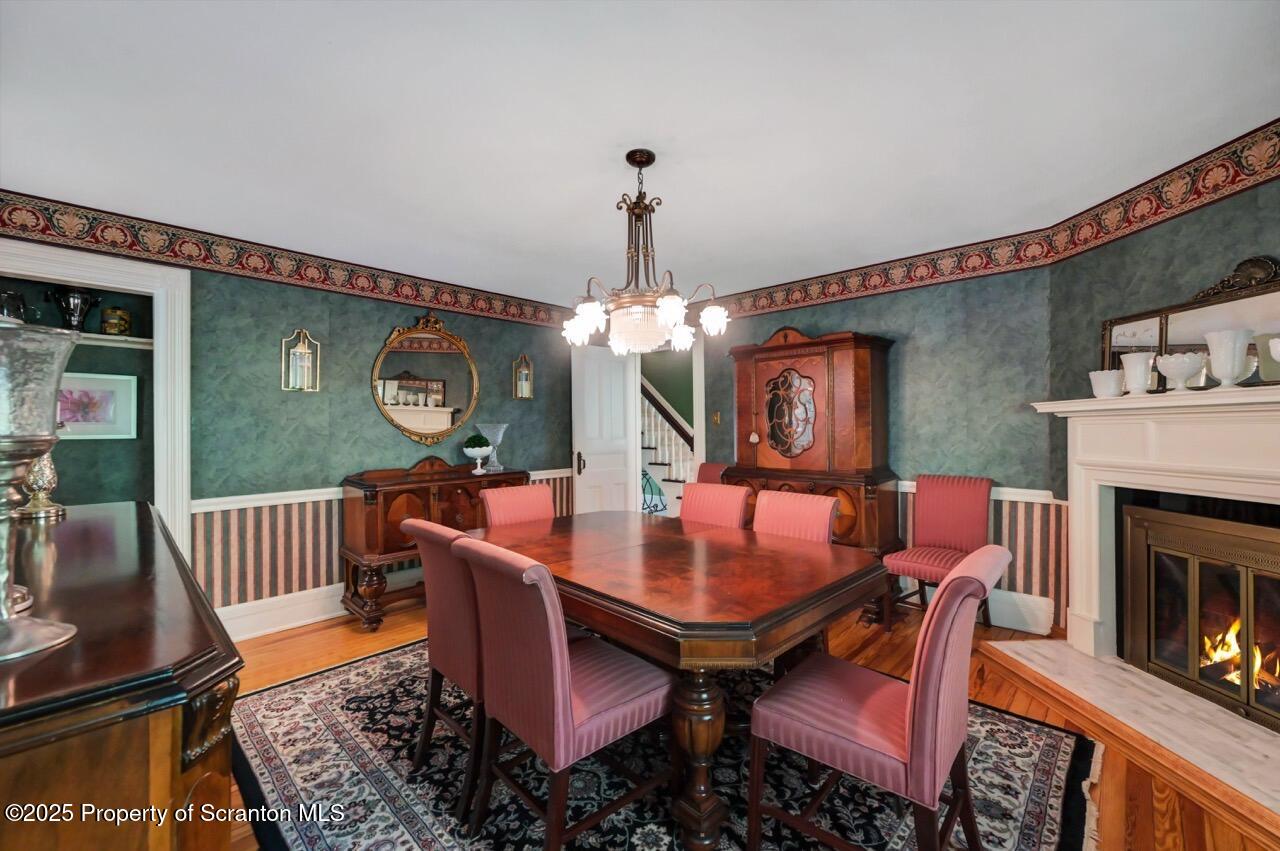 3360 Forest Road Wilkes Barre, PA 18706 - Photo 27 of 88 a dining room with furniture wooden floor a rug and a chandelier