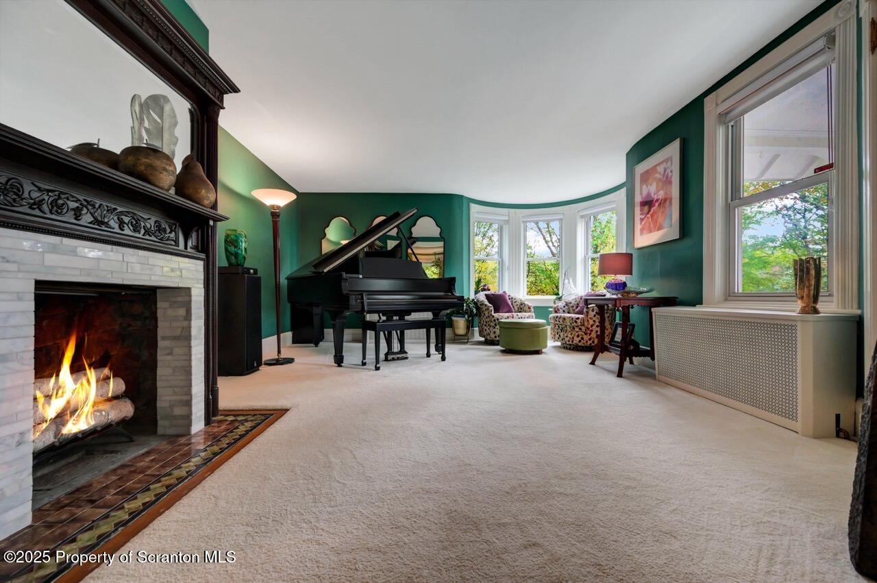 3360 Forest Road Wilkes Barre, PA 18706 - Photo 37 of 88 a living room with furniture a fireplace and a flat screen tv