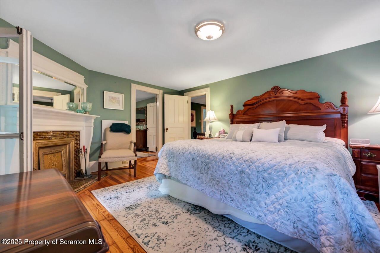 3360 Forest Road Wilkes Barre, PA 18706 - Photo 47 of 88 a bedroom with a bed and wooden floor