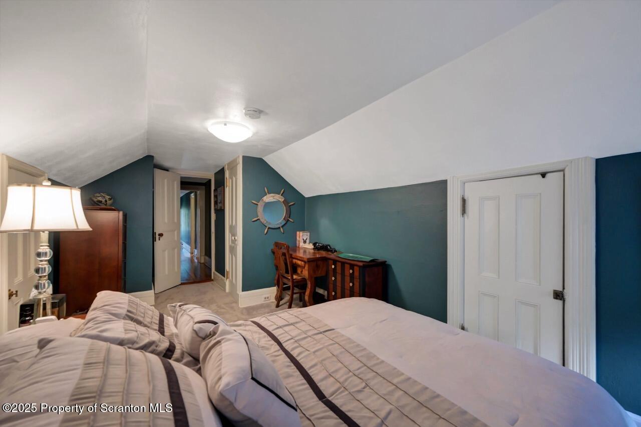 3360 Forest Road Wilkes Barre, PA 18706 - Photo 69 of 88 a bedroom with a bed and a chandelier