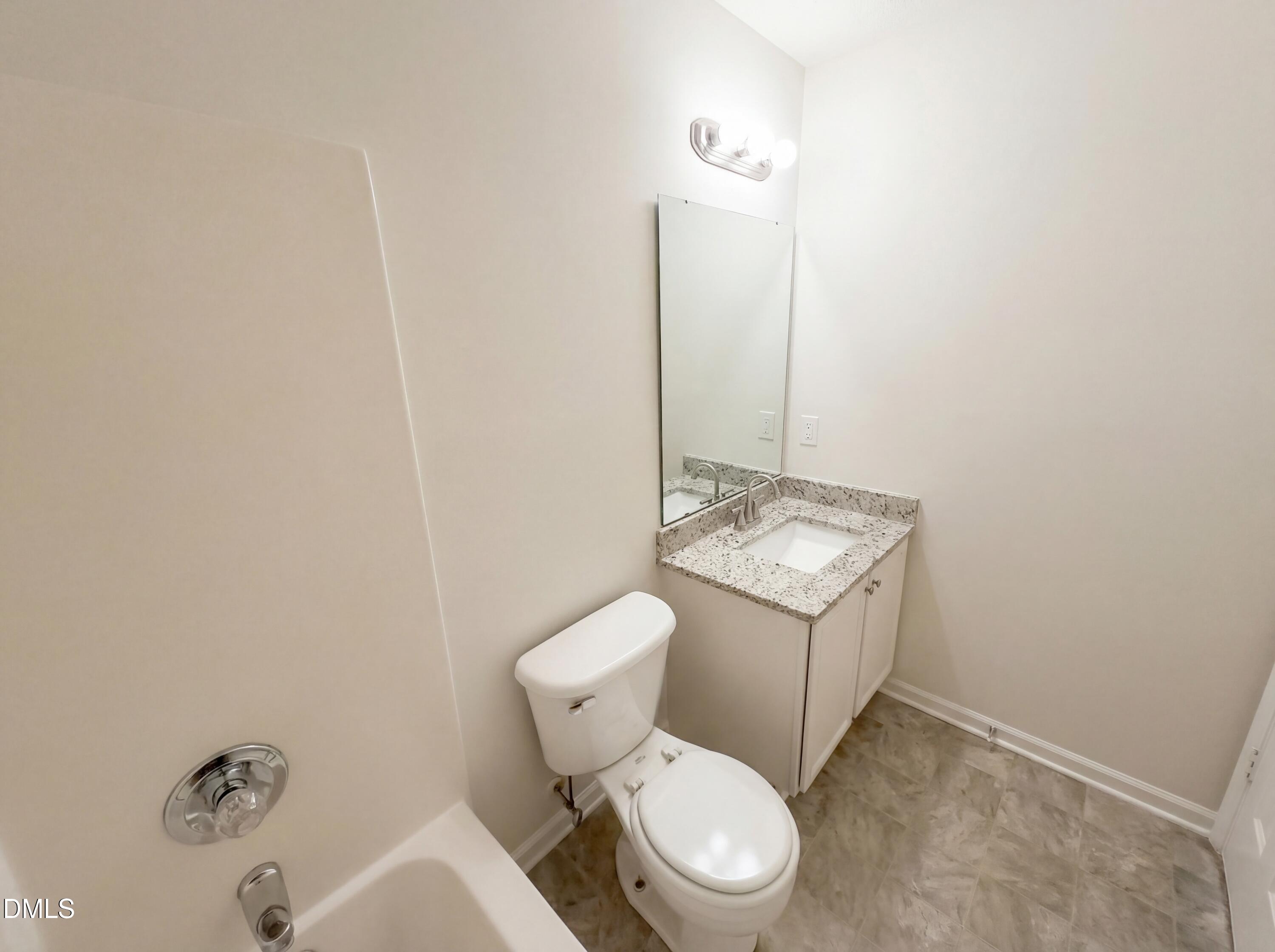 83 Eagle Rock Place Clayton, NC 27520 - Photo 11 of 16 a bathroom with a toilet sink and mirror