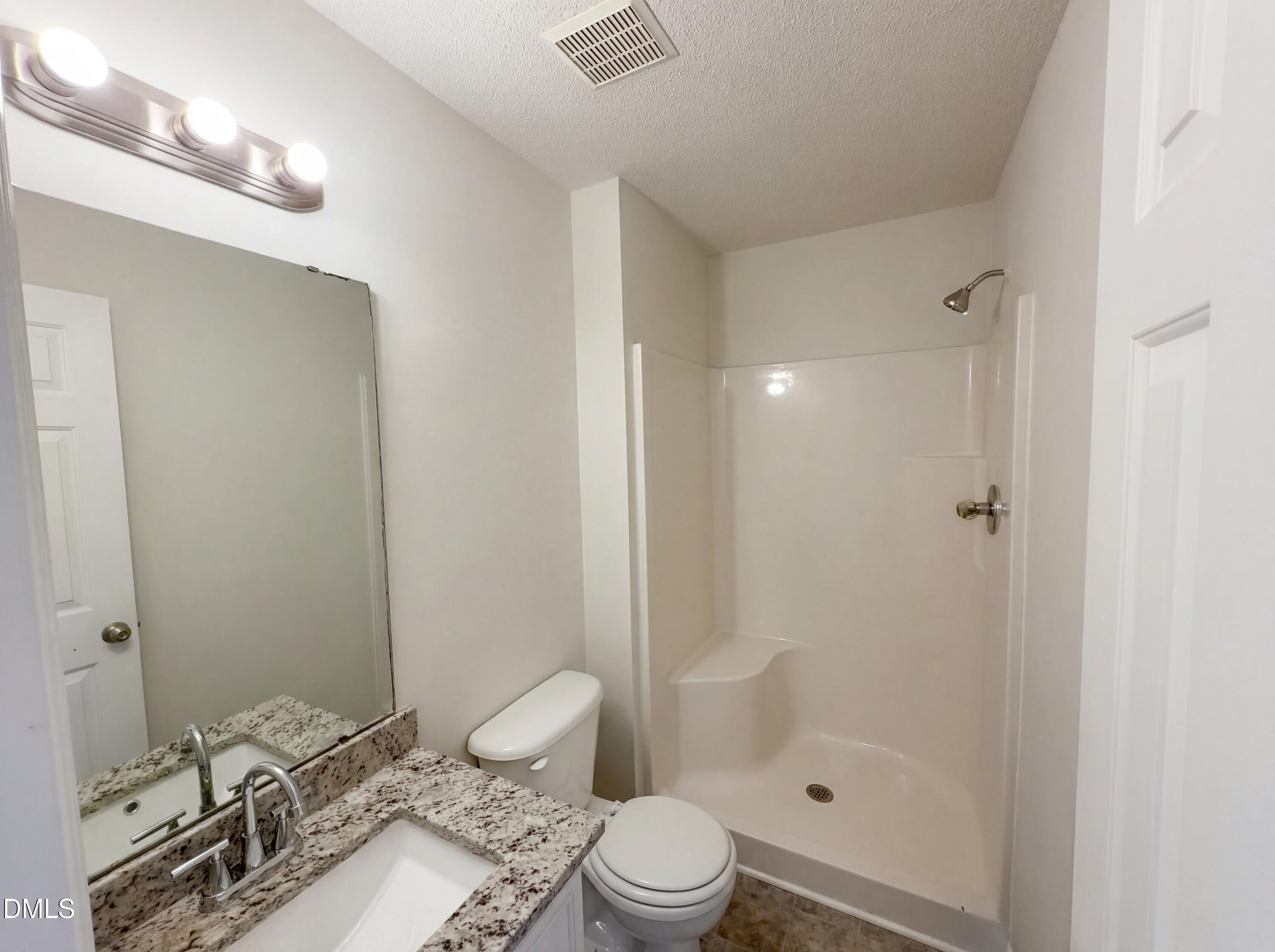 83 Eagle Rock Place Clayton, NC 27520 - Photo 6 of 16 a bathroom with a sink a toilet and shower