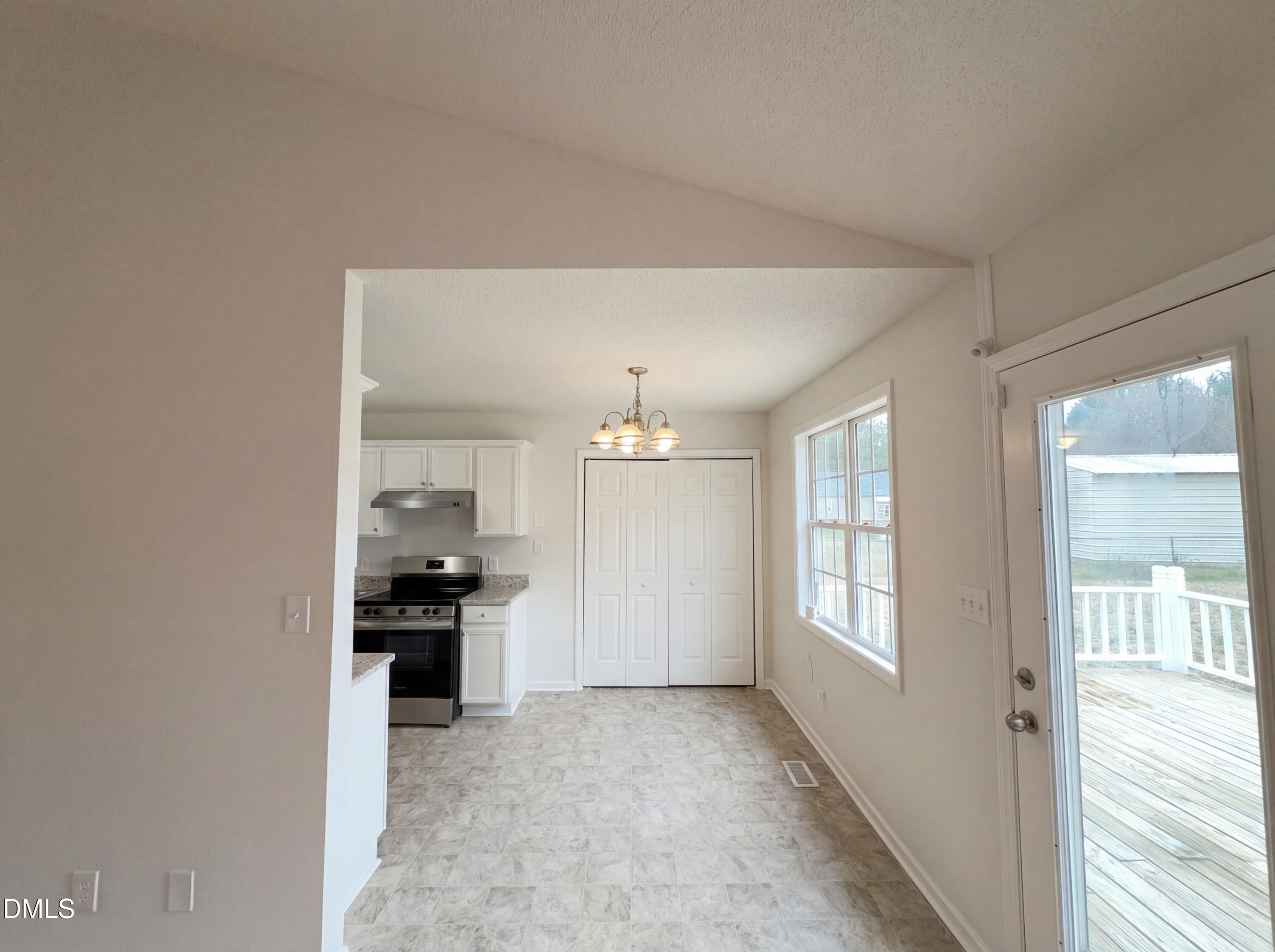 83 Eagle Rock Place Clayton, NC 27520 - Photo 7 of 16 a view of a kitchen and an entryway and an empty room
