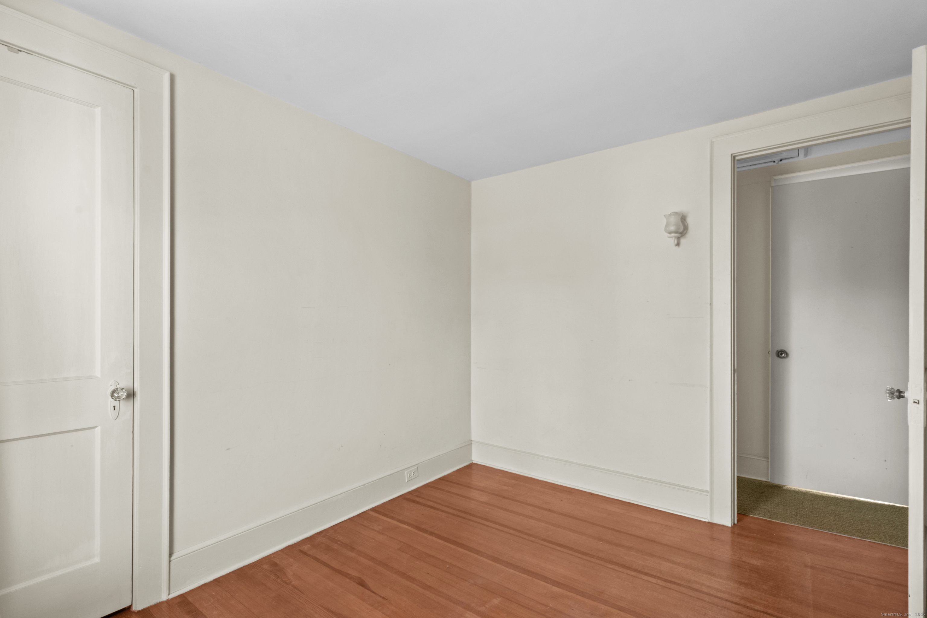 179 Verna Hill Road Fairfield, CT 06824 - Photo 17 of 36 a view of an empty room with wooden floor