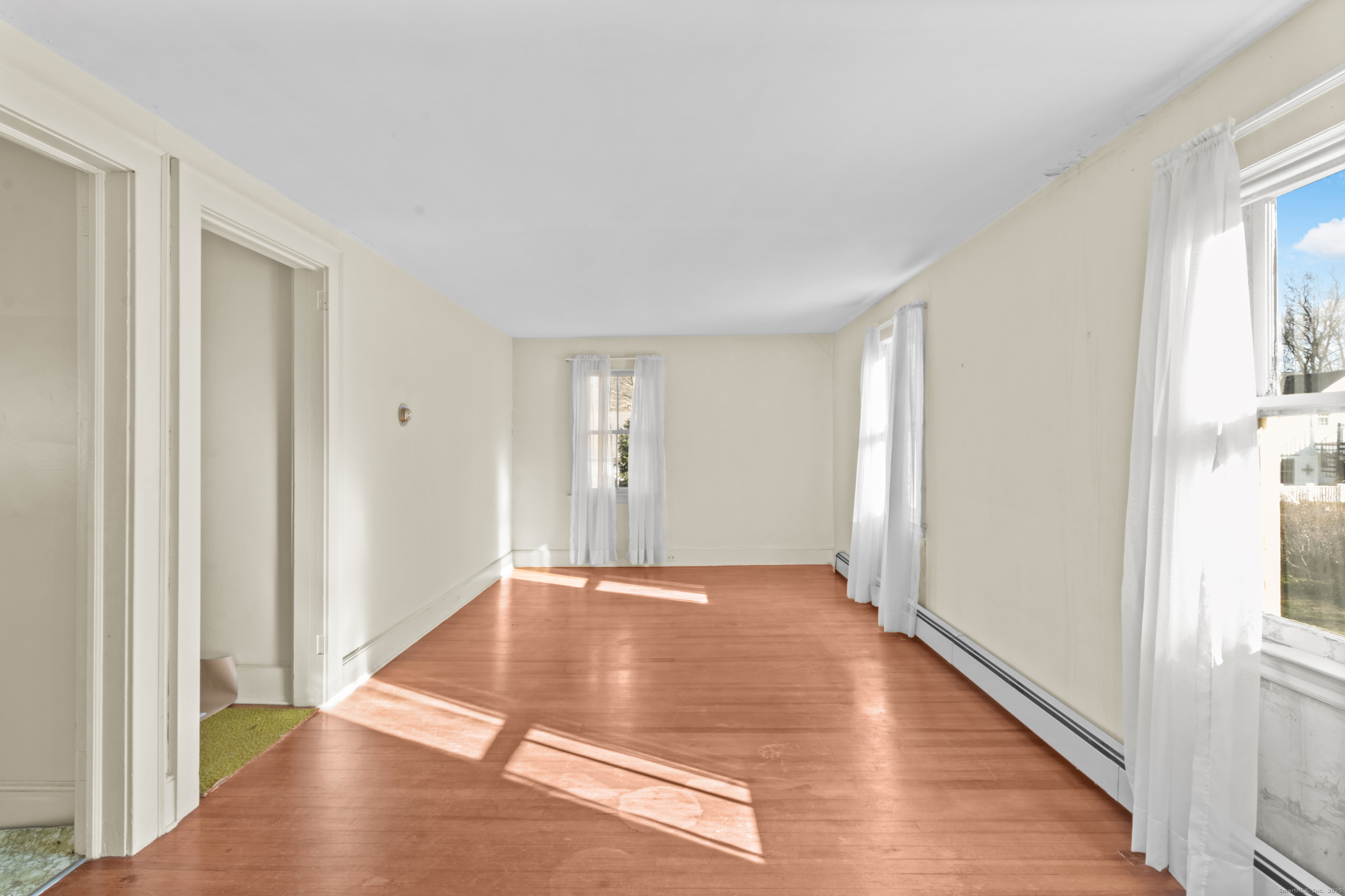 179 Verna Hill Road Fairfield, CT 06824 - Photo 24 of 36 a view of an empty room with wooden floor