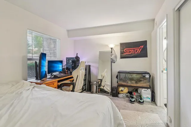 a bedroom with bed and a closet