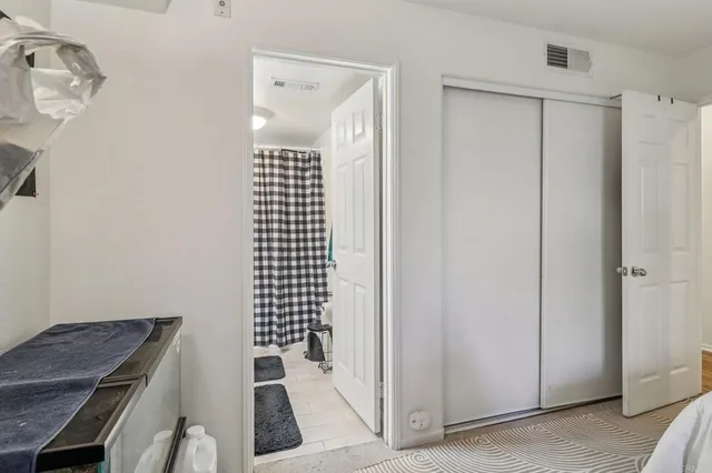 a bedroom with a bed and a mirror