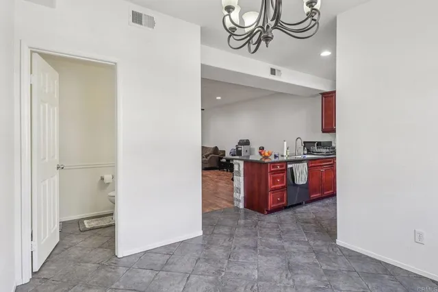 a bathroom with a granite countertop sink mirror vanity and toilet