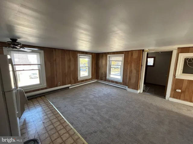 an empty room with windows and closet