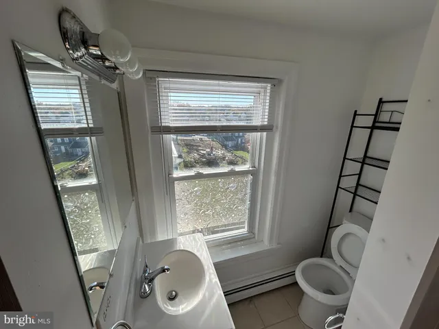 a bathroom with sink toilet and shower