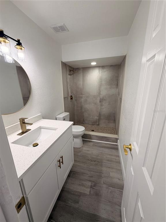 7513 Rustic Drive Tampa, FL 33634 - Photo 11 of 21 a bathroom with a sink a toilet and shower