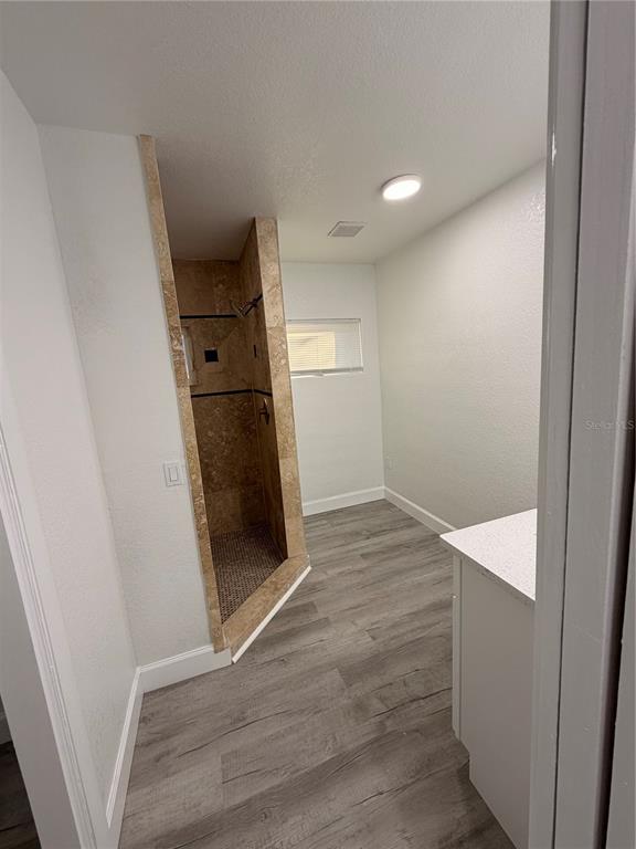 7513 Rustic Drive Tampa, FL 33634 - Photo 15 of 21 an empty room with wooden floor and entrance