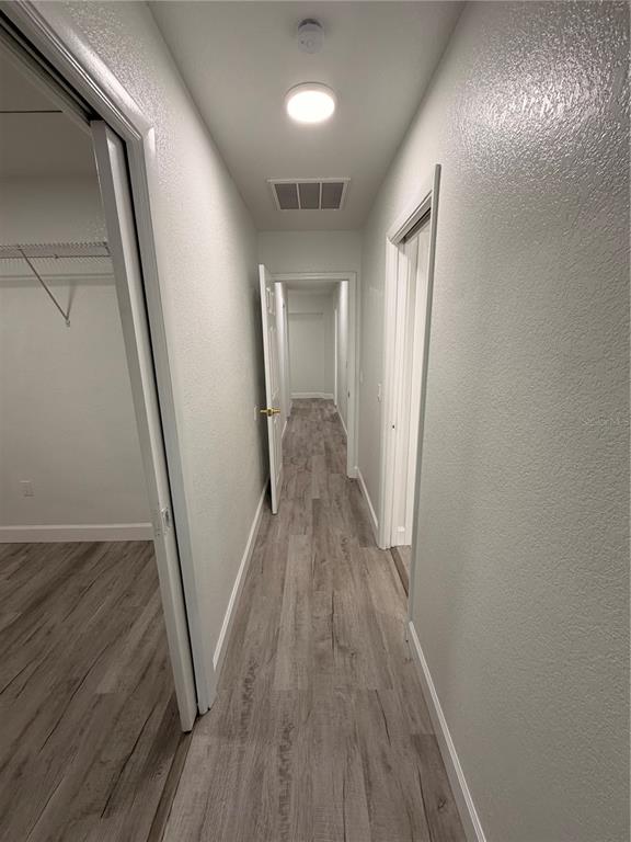 7513 Rustic Drive Tampa, FL 33634 - Photo 17 of 21 a view of a hallway with wooden floor
