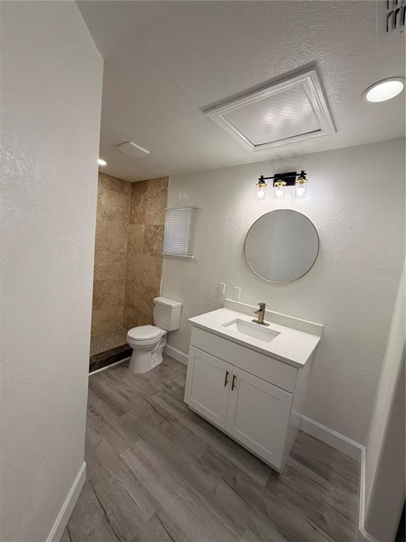 7513 Rustic Drive Tampa, FL 33634 - Photo 10 of 21 a bathroom with a granite countertop toilet a sink and a mirror