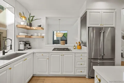 a kitchen with stainless steel appliances a refrigerator sink and cabinets