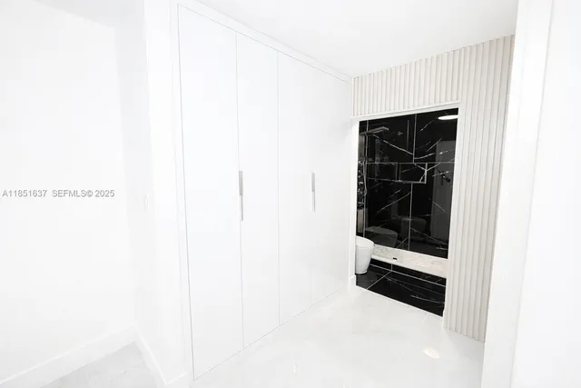 a bathroom with a glass shower door
