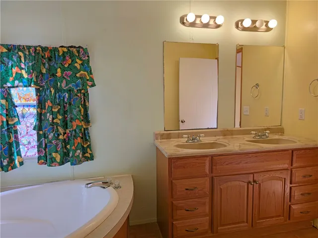 a bathroom with a granite countertop sink a vanity and a mirror
