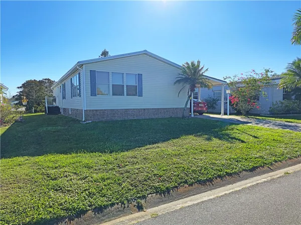 a view of backyard with barbeque grill and wooden fence