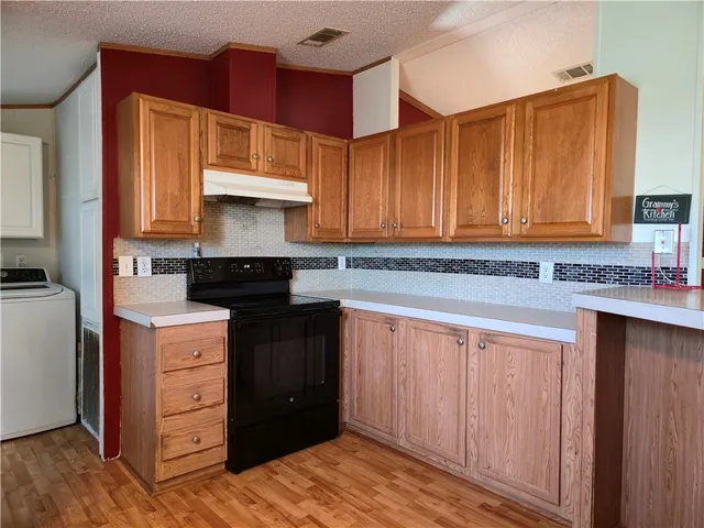 a kitchen with a cabinets and wooden floor