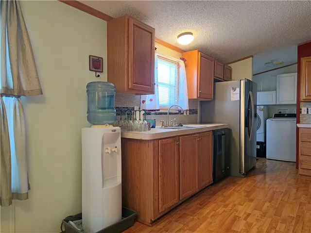 a kitchen with a refrigerator sink and cabinets