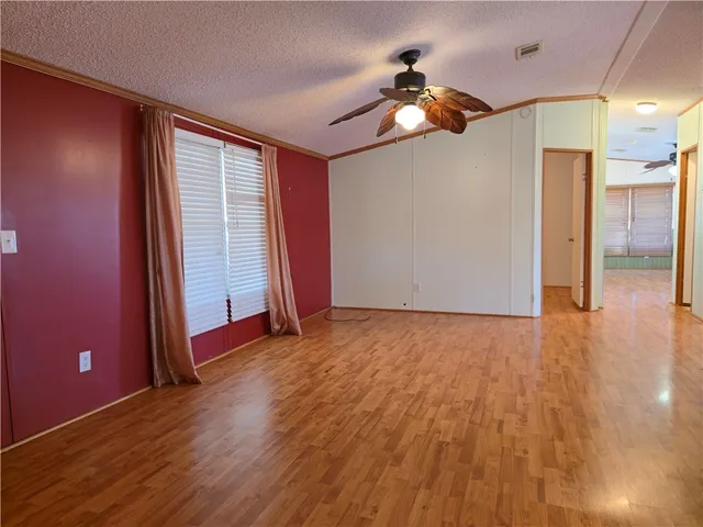 a view of a livingroom with a ceiling fan and window