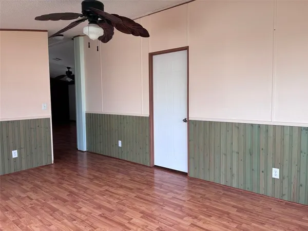 a view of a room with wooden floor