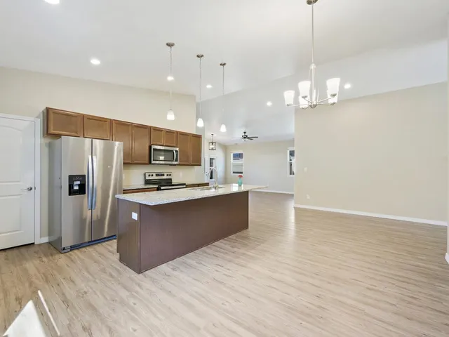 a kitchen with a sink and chandelier