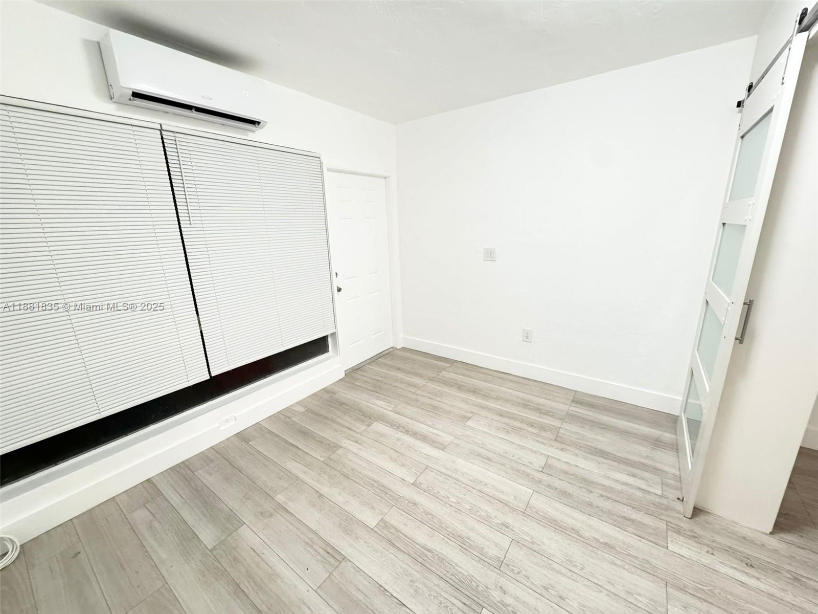 7435 Byron Avenue, Unit 2 Miami Beach, FL 33141 - Photo 12 of 35 a view of empty room with wooden floor