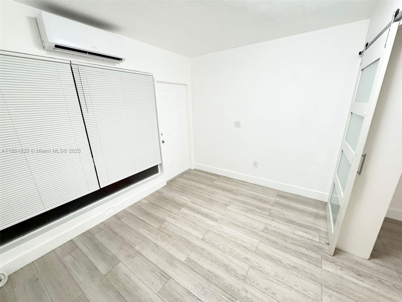 7435 Byron Avenue, Unit 2 Miami Beach, FL 33141 - Photo 13 of 35 a view of a room with wooden floor