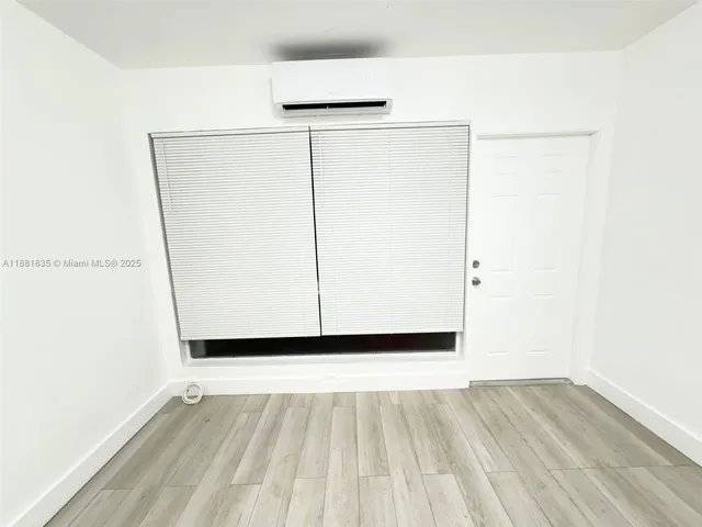 a view of a small space with wooden floor