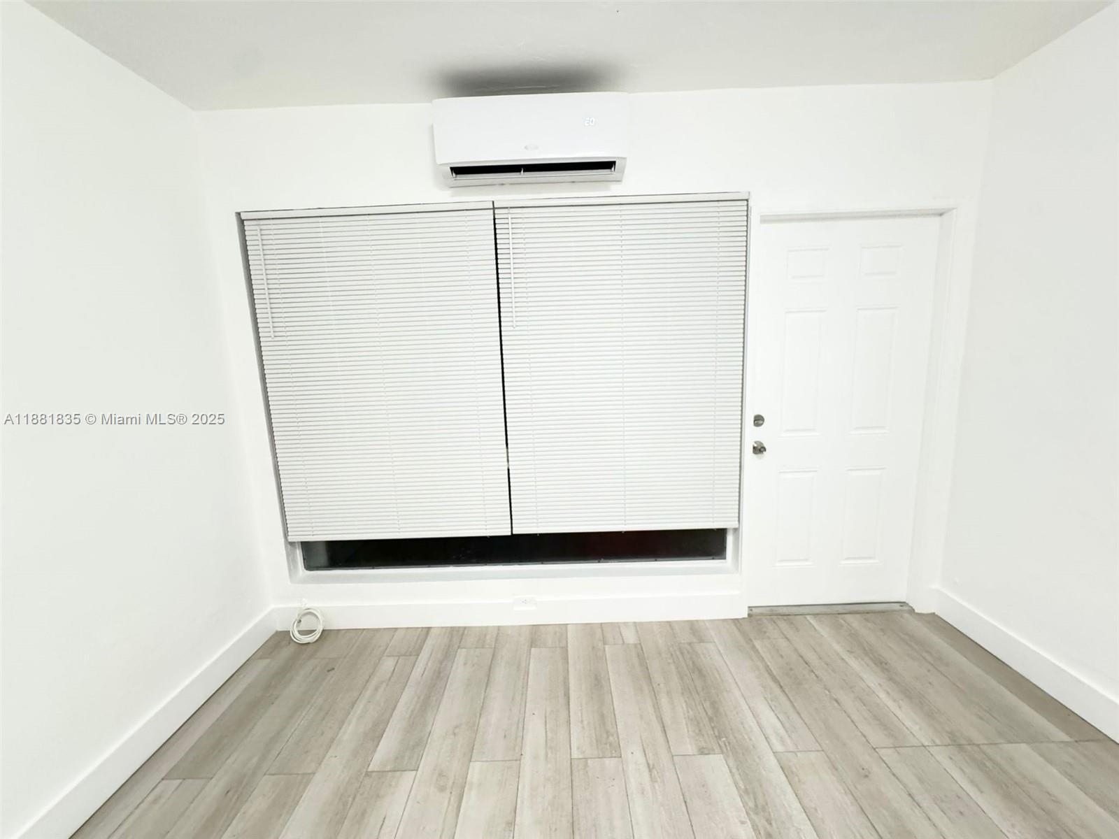 7435 Byron Avenue, Unit 2 Miami Beach, FL 33141 - Photo 14 of 35 a view of a small space with wooden floor