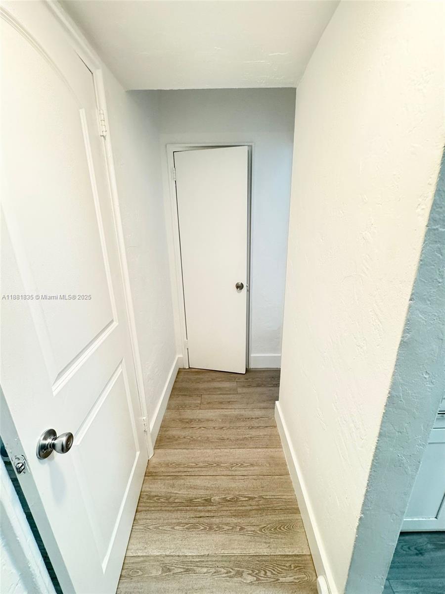 7435 Byron Avenue, Unit 2 Miami Beach, FL 33141 - Photo 15 of 35 a view of a hallway with wooden floor and entryway