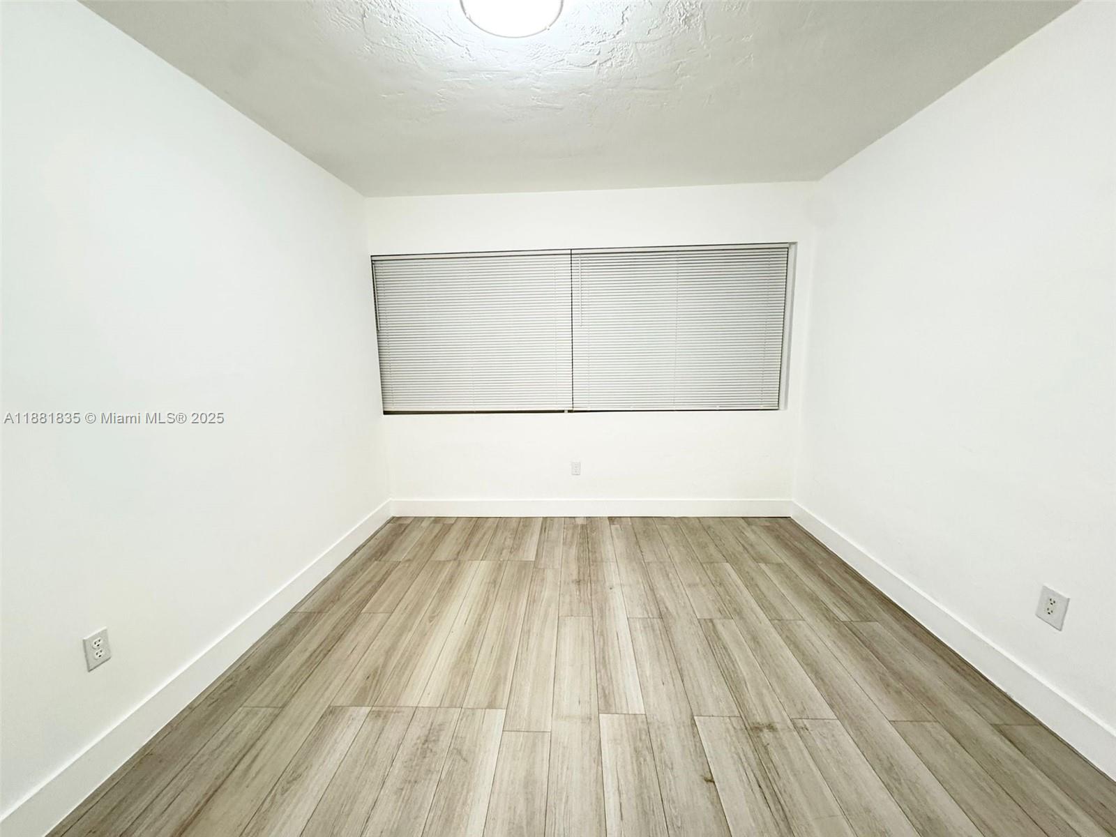 7435 Byron Avenue, Unit 2 Miami Beach, FL 33141 - Photo 19 of 35 a view of a room with wooden floor