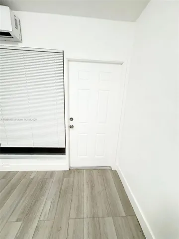 a view of a small space with wooden floor