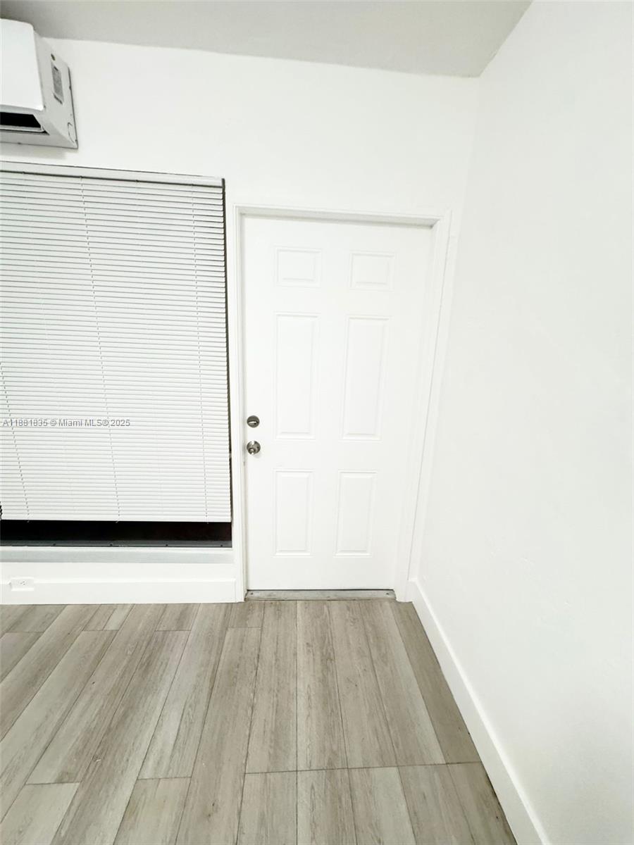 7435 Byron Avenue, Unit 2 Miami Beach, FL 33141 - Photo 20 of 35 a view of a small space with wooden floor