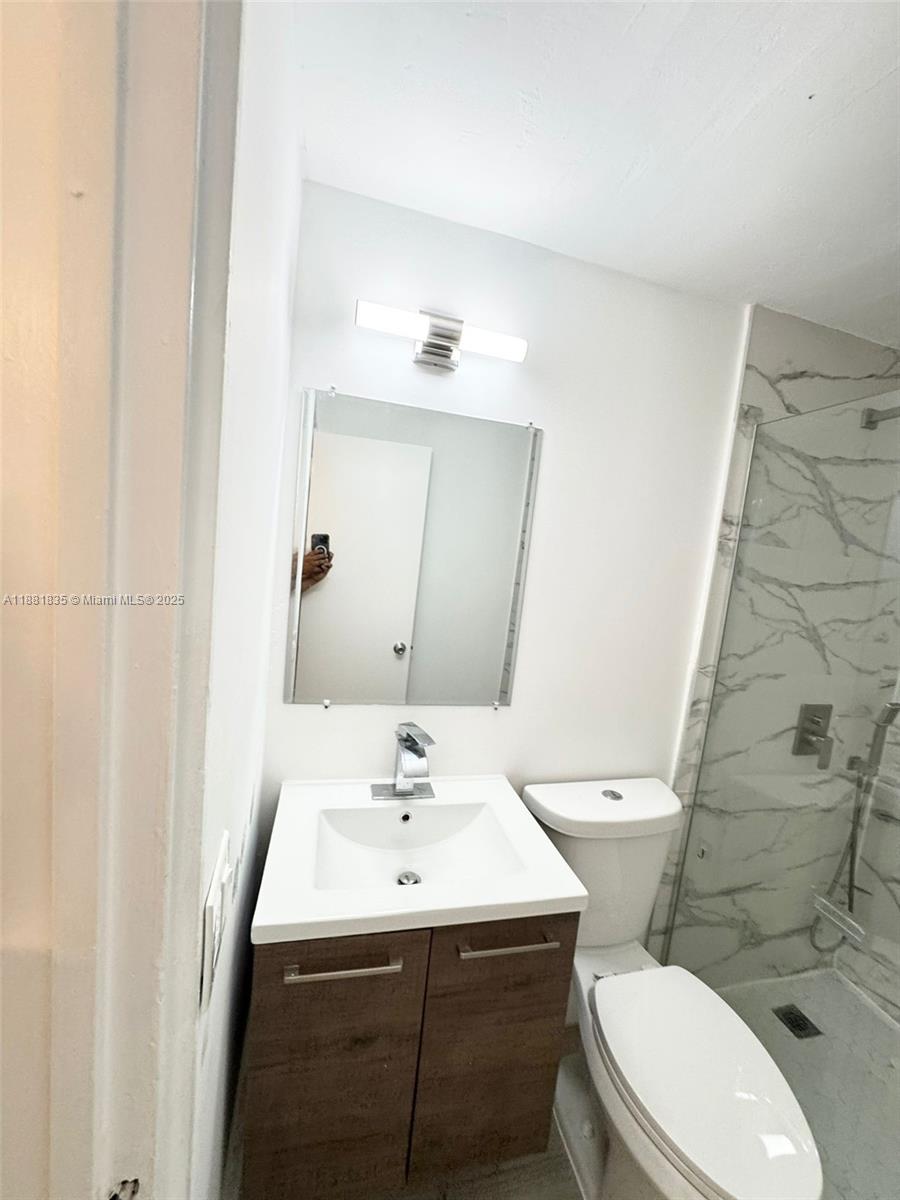 7435 Byron Avenue, Unit 2 Miami Beach, FL 33141 - Photo 22 of 35 a bathroom with a sink a toilet and shower