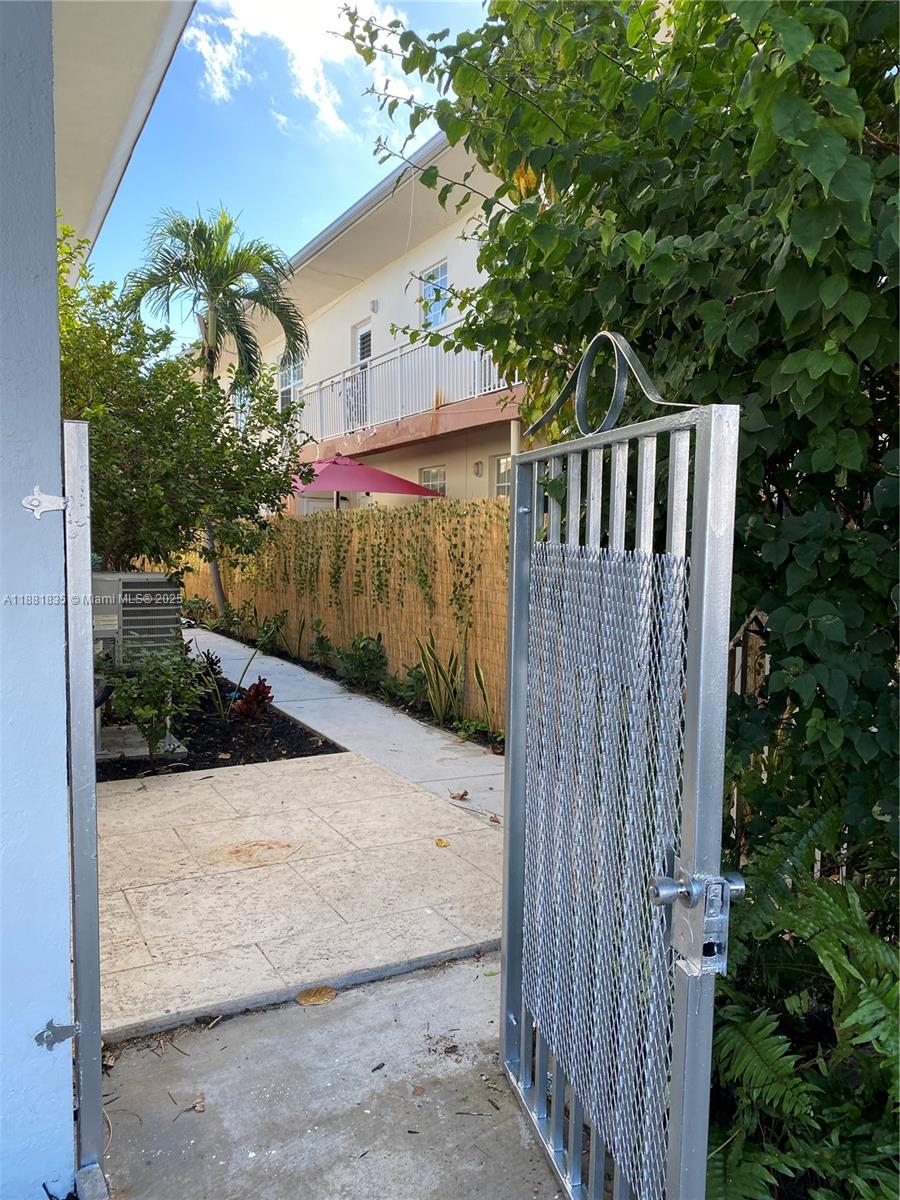 7435 Byron Avenue, Unit 2 Miami Beach, FL 33141 - Photo 32 of 35 a view of street along with house and trees