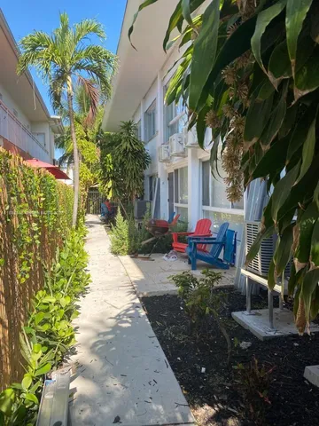 a backyard of a house with barbeque oven table and chairs
