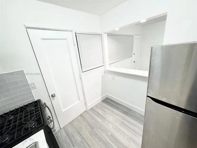 a view of storage and utility room with refrigerator
