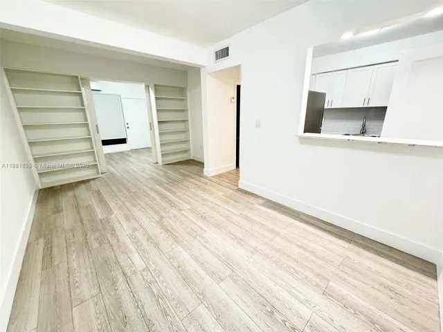 a view of an empty room with closet