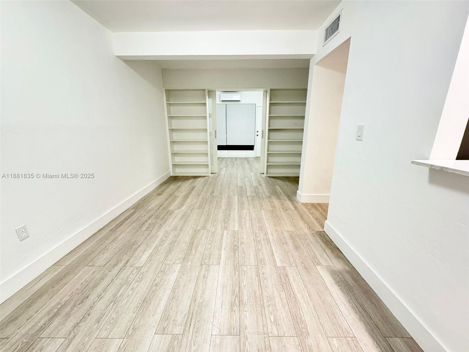 7435 Byron Avenue, Unit 2 Miami Beach, FL 33141 - Photo 7 of 35 a view of empty room with wooden floor