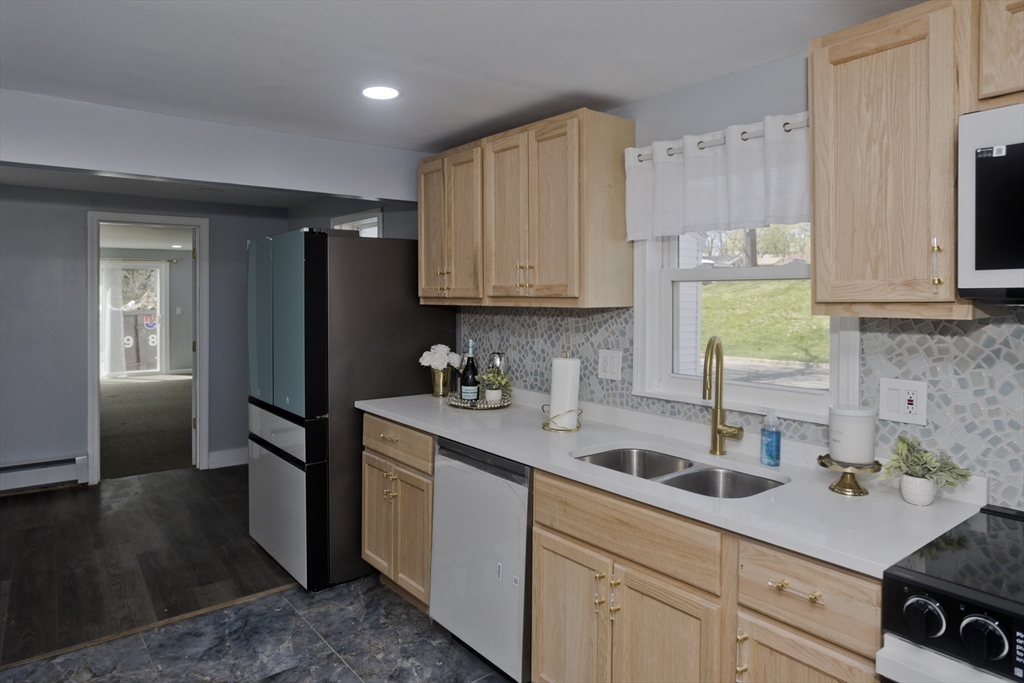 138 Stapleton Road Springfield, MA 01109 - Photo 12 of 38 a kitchen with a sink dishwasher a refrigerator and cabinets